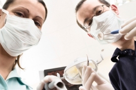 dentists looming over poor patient